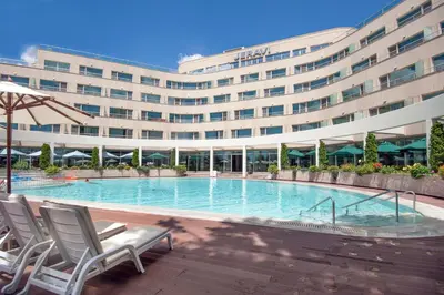 a large building with a swimming pool in front of a building at Jeravi Beach Hotel - All Inclusive in Sunny Beach