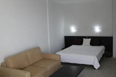 a hotel room with a bed and a couch at Galateya Sveti Vlas Bułgaria in Sveti Vlas