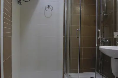 a shower with a glass door next to a sink at Galateya Sveti Vlas Bułgaria in Sveti Vlas