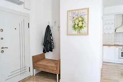 a room with a chair and a picture on the wall at KApartments in Varna City