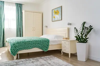 a bedroom with a bed and a potted plant at KApartments in Varna City