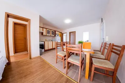 a kitchen and dining room with a table and chairs at Prestige Fort Beach - Full Board in Sveti Vlas