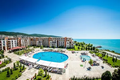 an aerial view of a resort with a swimming pool and the ocean at Prestige Fort Beach - Full Board in Sveti Vlas