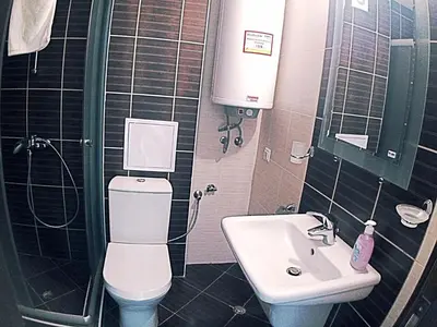 a small bathroom with a toilet and a sink at Chateau Del Marina Penthouses in Nesebar