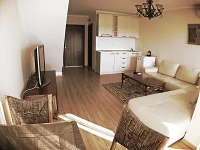 a living room with a couch and a table at Chateau Del Marina Penthouses in Nesebar
