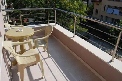 a balcony with a table and chairs on it at Guest House Donchevi in Primorsko
