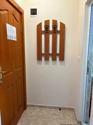 a hallway with a door and two signs on a wall at Family Hotel Chris in Sveti Vlas
