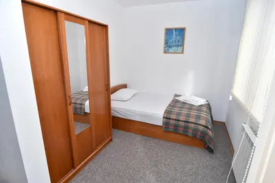a small bedroom with a small bed and a mirror at Family Hotel Saint Iliya in Burgas City