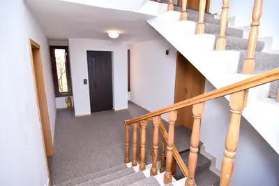 a winding staircase in a home with white walls at Family Hotel Saint Iliya in Burgas City