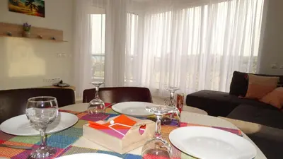 a dining room table with plates and wine glasses at July's Island Deluxe in Chernomorets