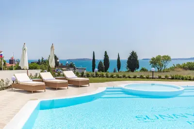 a swimming pool with two lounge chairs and a swimming pool at July's Island Deluxe in Chernomorets