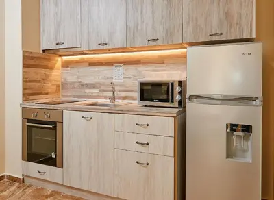 a kitchen with a refrigerator and a microwave at Апартаменти 