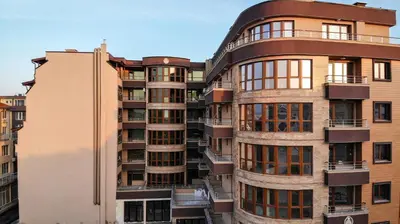 a tall building with balconies on the side of it at Апартаменти 