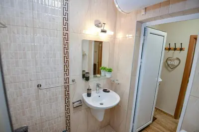 a bathroom with a sink and a mirror at Апартаменти 