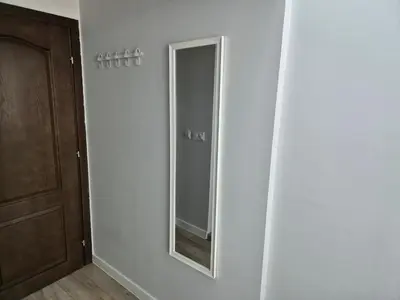 a mirror on a wall next to a door at Park and pool Studio Apostolovi in Nesebar