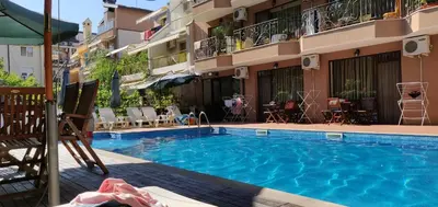 a swimming pool in front of a building at Park and pool Studio Apostolovi in Nesebar