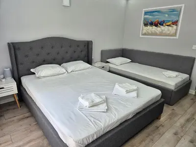 a bedroom with two beds with towels on them at Park and pool Studio Apostolovi in Nesebar