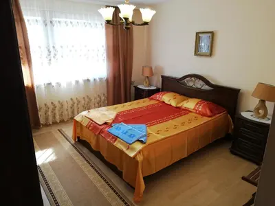 a bedroom with a bed and a window at апартамент Росен in Nesebar