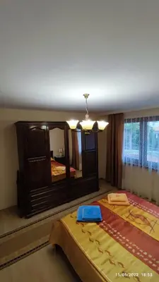 a bedroom with a large mirror and a bed at апартамент Росен in Nesebar