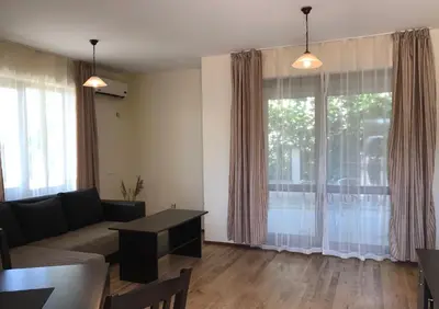 a living room with a couch and a table at Апартхотел Созополски перли in Sozopol