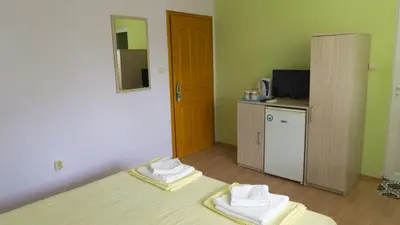 a room with a bed with two towels on it at Guest House Gardeli in Tsarevo