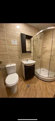 a bathroom with a toilet and a sink and a shower at Private Apartment 49 in Prestige Fort Beach Hotel in Sveti Vlas