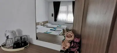 a small room with a mirror and a bed at Къща за гости Слънчевият ъгъл - The sunny corner in Sozopol