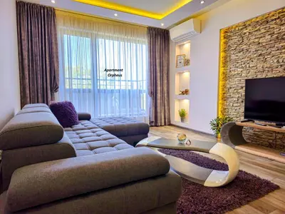 a living room with a couch and a television at Apartments Cats in Varna City