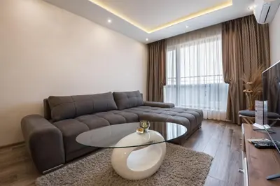 a living room with a couch and a glass table at Apartments Cats in Varna City