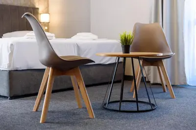 two chairs and a table in a hotel room at Avenue Hotel Deluxe in Burgas City