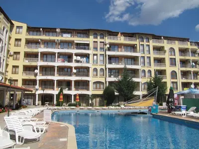 a hotel with a swimming pool in front of a building at SB Rentals Apartments in Royal Dreams Complex in Sunny Beach