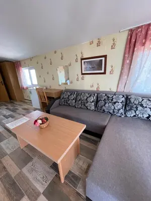 a living room with a couch and a table at The White House in Bliznatsi