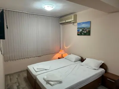 a small bedroom with two beds and a lamp at Casa Luba Sunny beach in Sunny Beach