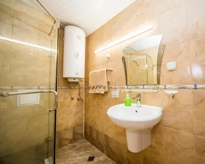 a bathroom with a sink and a shower at Aleksapart in Burgas City