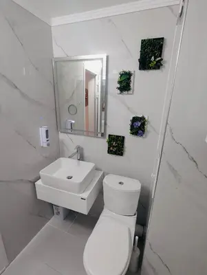 a white bathroom with a toilet and a sink at CHATEAU DEL MAR C31a Studio Sunny Beach in Sunny Beach