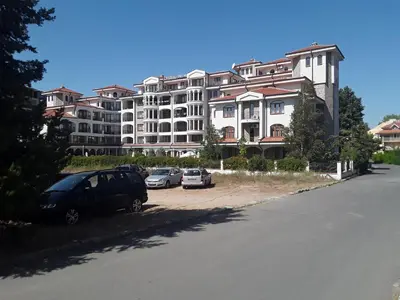 a large apartment building with cars parked in a parking lot at CHATEAU DEL MAR C31a Studio Sunny Beach in Sunny Beach