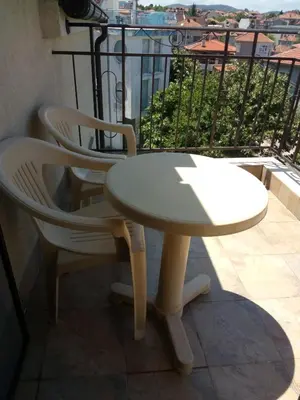 a white table and two chairs on a balcony at Family Hotel Bellehouse in Chernomorets