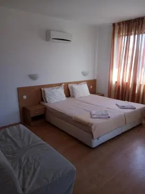 a bedroom with two beds and a window at Family Hotel Bellehouse in Chernomorets