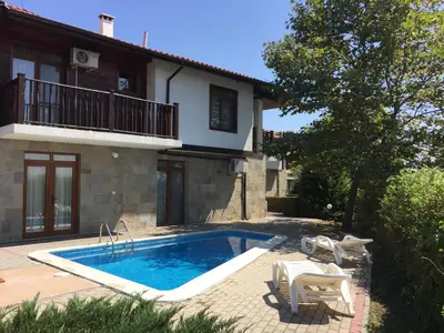 a swimming pool in front of a house at HillTop Villa in Burgas City