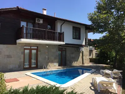 a swimming pool in front of a house at HillTop Villa in Burgas City