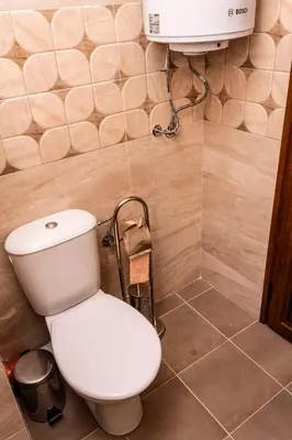 a bathroom with a white toilet and a sink at New Star Residence in Burgas City
