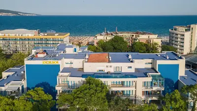 a group of buildings in front of the ocean at Excelsior Holiday Apartments Sunny Beach in Sunny Beach