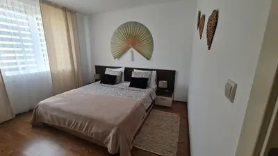 a bedroom with a bed and a large window at Atia Resot in Chernomorets