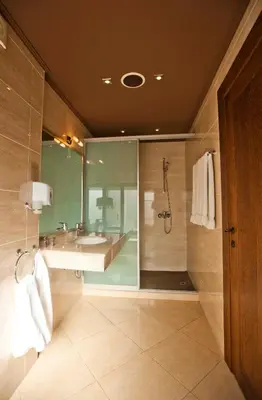 a large bathroom with a shower and a sink at Ventura Boutique Hotel in Varna City