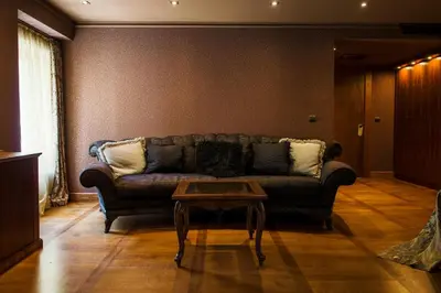 a living room with a couch and a coffee table at Ventura Boutique Hotel in Varna City
