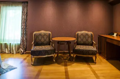 two chairs and a table in a room at Ventura Boutique Hotel in Varna City