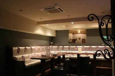 a dining room with a long table and chairs at Ventura Boutique Hotel in Varna City