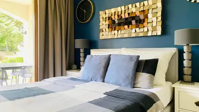 a bedroom with a bed with blue walls at APARTELLO Modern Apartments - CASA REAL in Sveti Vlas in Sveti Vlas