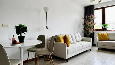 a living room with a couch and a table at APARTELLO Modern Apartments - CASA REAL in Sveti Vlas in Sveti Vlas