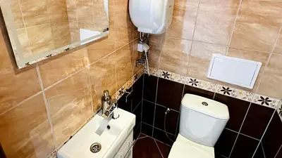 a small bathroom with a toilet and a sink at APARTELLO Modern Apartments - CASA REAL in Sveti Vlas in Sveti Vlas